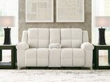 Ashley Furniture Orlen reclining loveseat with console, featuring plush fabric, padded armrests, and built-in cup holders.