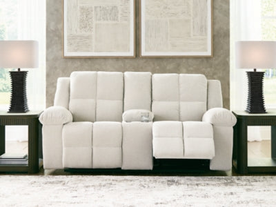 Ashley Furniture Orlen reclining loveseat with console, showing plush upholstery and built-in cupholders in a relaxed open position.