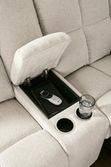 Ashley Furniture Orlen reclining loveseat with console, featuring plush fabric, built-in cup holders, and cushioned armrests.