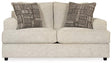 Ashley Furniture Soletren loveseat with plush fabric, featuring a cozy, modern design and cushioned armrests.