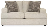 Ashley Furniture Soletren loveseat with plush fabric, featuring a cozy, modern design and cushioned armrests.