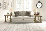 Ashley Furniture Soletren loveseat in gray fabric with plush cushions and tapered wood legs, perfect for modern living rooms.