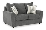Ashley Furniture Stairatt loveseat with plush fabric upholstery and cushioned armrests in a contemporary living room setting.