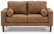 Ashley Telora loveseat with plush fabric upholstery, featuring comfortable cushions and a modern design.