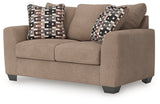 Ashley Furniture Triston-Peaks loveseat shown from an angled view, featuring plush fabric and comfortable, stylish seating.