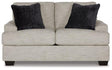 Ashley Vayda loveseat with plush fabric and modern design, featuring comfortable cushions and sleek armrests.