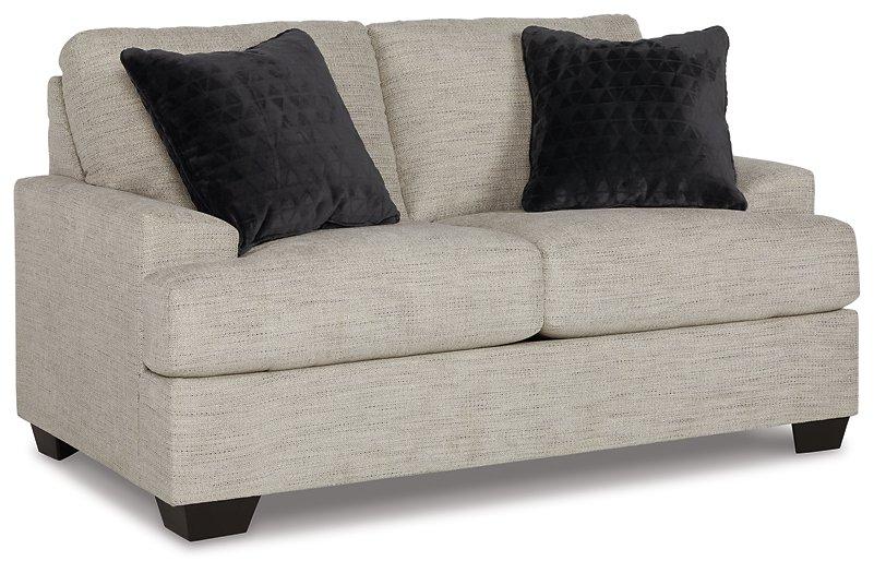 Ashley Vayda loveseat in beige fabric with plush cushions and wooden legs, perfect for a cozy living room seating area.