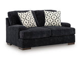 Ashley Furniture Whitmore Manor loveseat with plush fabric and elegant design, shown from an angled view.