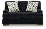 Ashley Furniture Whitmore Manor loveseat with plush fabric and rolled arms, shown from a head-on view.