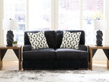 Ashley Furniture Whitmore Manor loveseat with plush fabric, featuring cushioned arms and a cozy, inviting design.