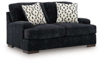 Ashley Furniture Whitmore Manor loveseat with plush fabric and elegant design, shown from an angled side view.