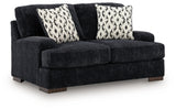 Ashley Furniture Whitmore Manor loveseat with plush fabric and elegant design, shown from an angled side view.