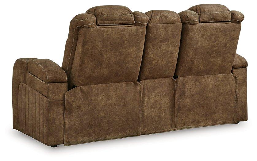 Ashley Furniture Wolfridge power reclining loveseat with plush upholstery and built-in recline mechanism, shown in a comfortable living room setting.