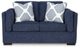 Ashley Furniture Evansley loveseat with plush fabric and cushioned arms, perfect for cozy living room seating.