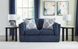 Ashley Furniture Evansley loveseat with plush beige fabric, cushioned armrests, and cozy seating for living room comfort.