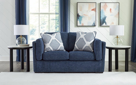 Ashley Furniture Evansley loveseat with plush beige fabric, cushioned armrests, and cozy seating for living room comfort.