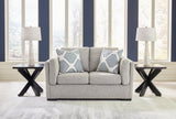 Ashley Furniture Evansley loveseat with plush fabric and cushioned arms, perfect for cozy living room seating.