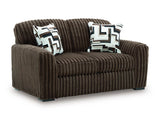 Ashley Furniture Midnight-Madness Loveseat showing plush gray upholstery and stylish armrests from a side angle.