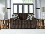Midnight Madness loveseat by Ashley Furniture featuring plush dark upholstery and contemporary design, close-up shot.