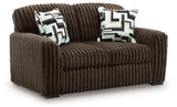 Ashley Furniture Midnight-Madness loveseat shown from an angle, featuring dark upholstery and plush cushions for comfortable seating.
