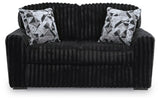 Ashley Furniture Midnight-Madness Loveseat with plush dark fabric, cozy cushions, and modern design in a stylish living room setting.