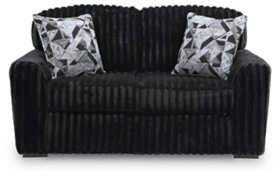 Ashley Furniture Midnight-Madness Loveseat with plush dark fabric, cozy cushions, and modern design in a stylish living room setting.
