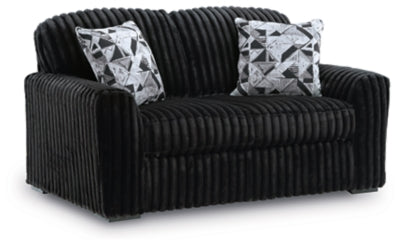 Ashley Furniture Midnight-Madness Loveseat with plush gray upholstery and sleek design, shown from an angled side view.
