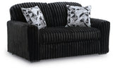 Ashley Furniture Midnight-Madness Loveseat with plush gray upholstery and sleek design, shown from an angled side view.