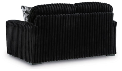 Ashley Furniture Midnight-Madness loveseat with plush dark upholstery and comfortable back cushions.