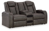 Ashley Furniture Fyne-Dyme power reclining loveseat with center console, featuring plush upholstery and reclining seats in an angled view.