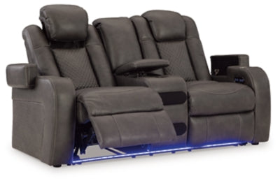 Ashley Furniture Fyne-Dyme power reclining loveseat with console, shown from an open angle highlighting plush upholstery and built-in cup holders.