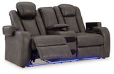 Ashley Furniture Fyne-Dyme power reclining loveseat with console, shown from an open angle highlighting plush upholstery and built-in cup holders.