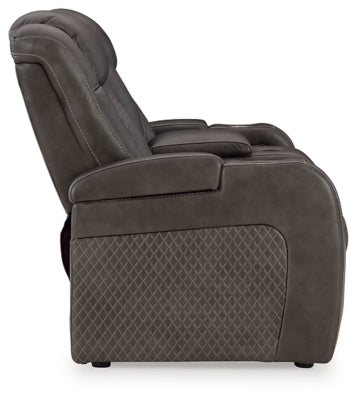 Ashley Furniture Fyne-Dyme Power Reclining Loveseat with Console, showing plush upholstery and built-in cup holders from the side view.