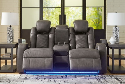 Ashley Furniture Fyne-Dyme power reclining loveseat with console, showing plush fabric, built-in cup holders, and reclining features.
