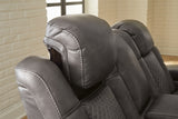 Ashley Furniture Fyne-Dyme power reclining loveseat with console, featuring plush cushions and built-in cup holders for comfort.