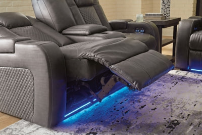 Ashley Furniture Fyne-Dyme power reclining loveseat with console, showing plush fabric, reclining mechanism, and built-in cup holders.