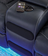 Ashley Furniture Fyne-Dyme power reclining loveseat with built-in Bluetooth audio, featuring a console and plush blue upholstery.