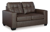 Ashley Furniture Barlin Mills loveseat with plush cushions and wooden legs, shown from an angled side view.