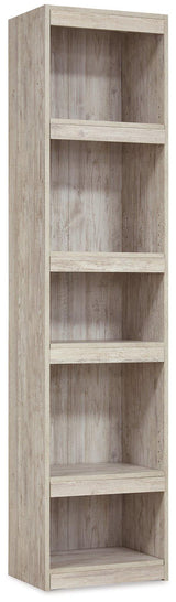 Willowton Pier media tower by Ashley Furniture featuring multiple shelves and storage compartments in a modern design.