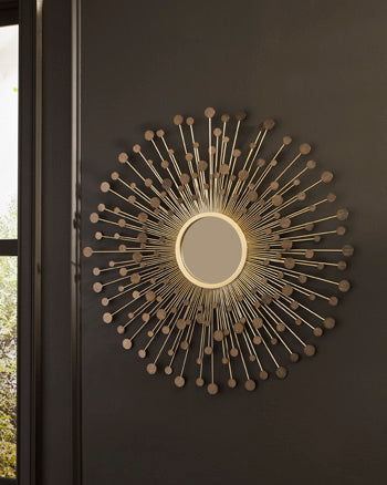 Ashley Furniture Morwenna Accent Mirror hanging on a wall with a decorative frame and reflective glass surface.