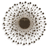 Ashley Furniture Morwenna accent mirror with a decorative frame, hanging on a wall in a modern interior setting.