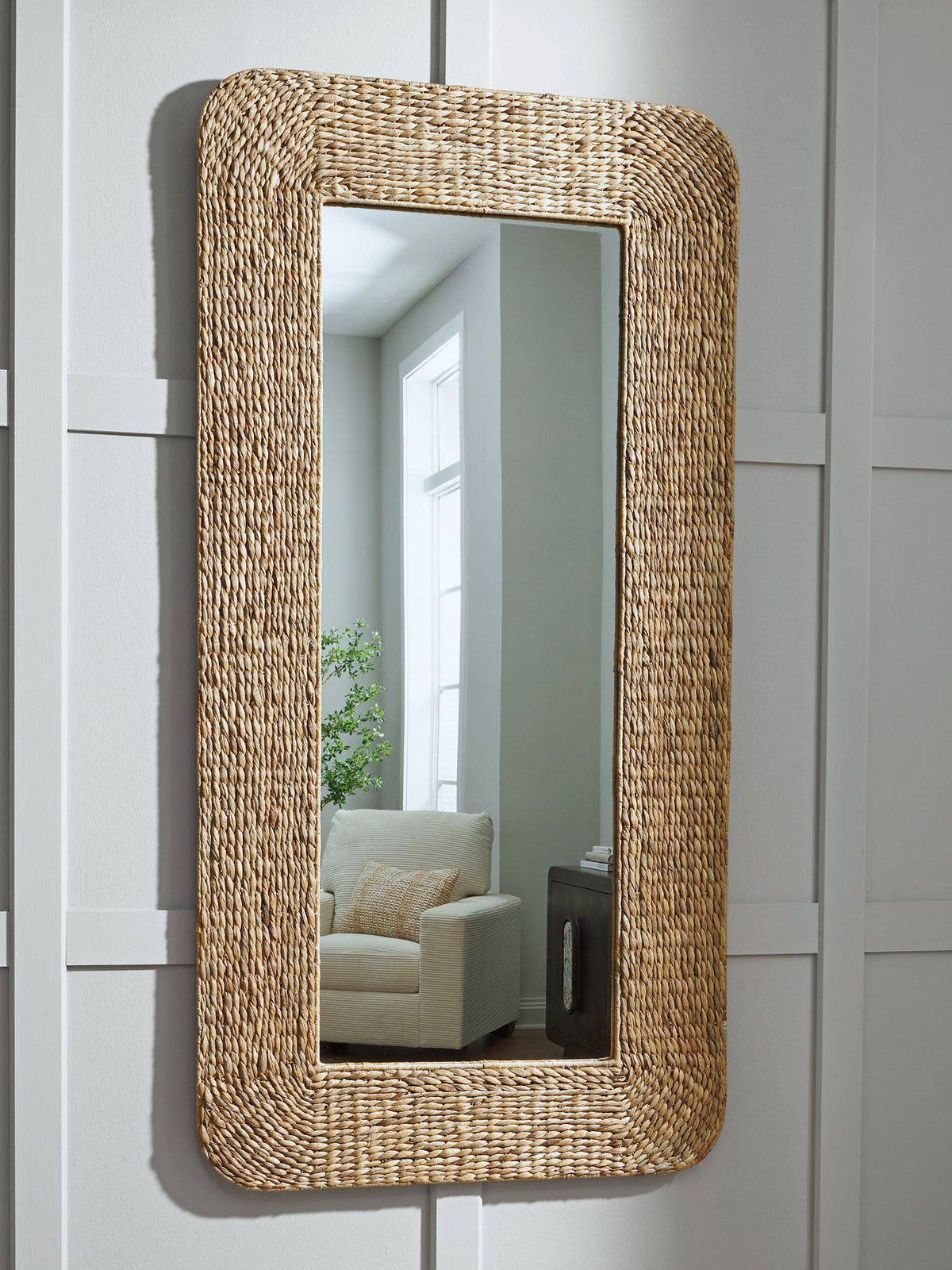 Ashley Furniture Norigan floor mirror with a sleek, modern frame, standing upright in a stylish room setting.