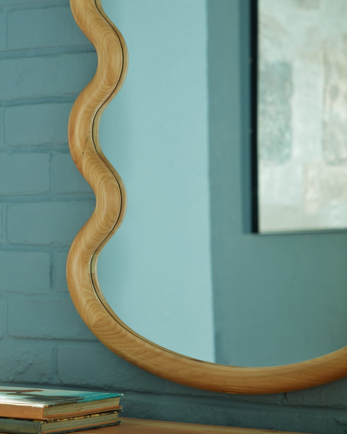 Ashley Furniture Serendis Accent Mirror with a sleek round frame, perfect for adding style to any room decor.