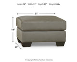 Ashley Furniture Darcy Ottoman with plush fabric and wooden legs, showcasing a stylish and comfortable accent piece for living rooms.