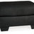 Ashley Furniture Darcy Ottoman showing a plush fabric surface and wooden legs, versatile piece for living room decor.