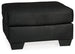 Ashley Furniture Darcy Ottoman showing a plush fabric surface and wooden legs, versatile piece for living room decor.