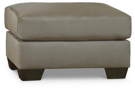 Ashley Furniture Darcy Ottoman with plush fabric and tufted top, ideal for living room or bedroom decor.