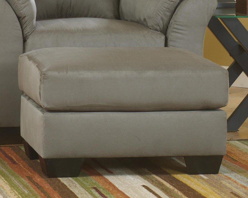 Ashley Furniture Darcy Ottoman with soft fabric upholstery and tufted top, perfect for living room or bedroom decor.