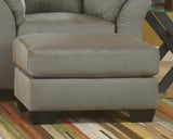 Ashley Furniture Darcy Ottoman with soft fabric upholstery and tufted top, perfect for living room or bedroom decor.