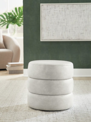 Ashley Furniture Ummi Swivel Accent Ottoman featuring a cushioned top and stylish design for versatile home decor.